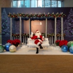 Santa Wayne on a bench waiting for guests to take photos and greet