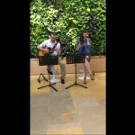 Singer and guitarist performing at Pacific place in Hong kong, casual summer vibe