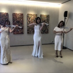 Led violin performance in white dress