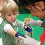 Our professional makeup artist, spraying a child.
