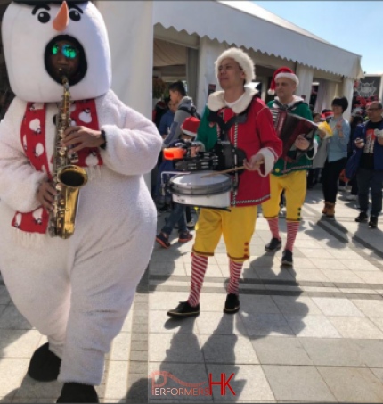 3 different instruments musicians walk around xmas music band in hong kong