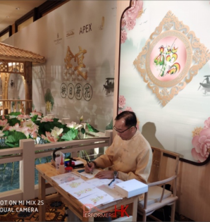 Event artist in macau doing rainbow calligraphy in white chinese costume