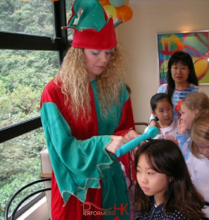 A Lady dress as a Christmas Elf at a hong Kong school Xmas event and doing a wraps for the students.