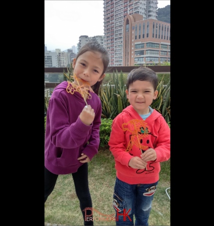 2 young children with Sugar painting (糖画) at event