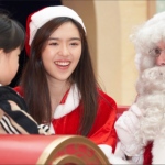 Santa with Santa girl talking to child