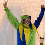 Hong Kong walk around clown juggler holding his both hands up at an event