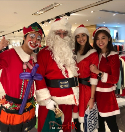 santa walking with his team including balloon elf and 2 lady santa