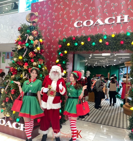 models in elf costume in front of coach hk store in causeway bay hong kong
