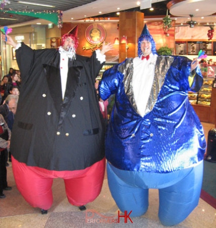Stilt walker in inflatable fat formal attire costume at a cafe in Hong Kong