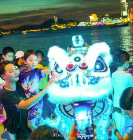 led lion lit up in wan chai harbour front next to wan chai ferry pier