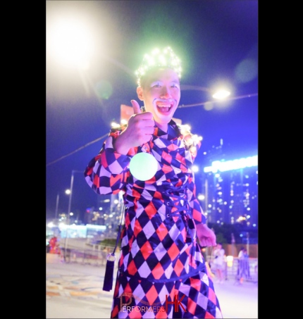 perfomers hk adds an led crown on top of the stilt costume to make it illuminate for event hired by hktb