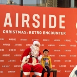 Big Phil Santa @ Airside Mall Kai Tak waving with young child