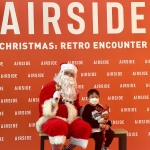 Big Phil Santa @ Airside Mall Kai Tak sitting with a child