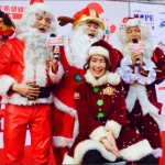 Mario with his team of other Santa at an event with Santa girl Kiwi