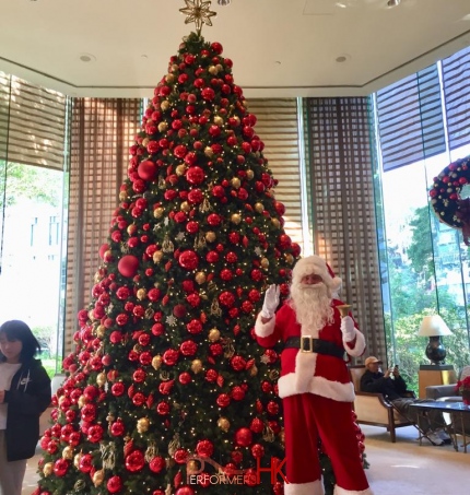 in front of the giant christmas tree in conrad hotel, admiralty, hong kong, decemeber 2025