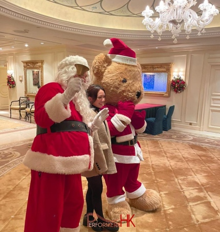 standing with giant bear mascot taking pictures with guests 2024 december, tsim tsai tsui, hong kong