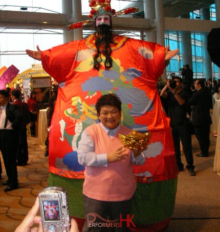 Giant Choi Sun performer in HK in inflatable costume taking picture with a gentlemen at corporate event